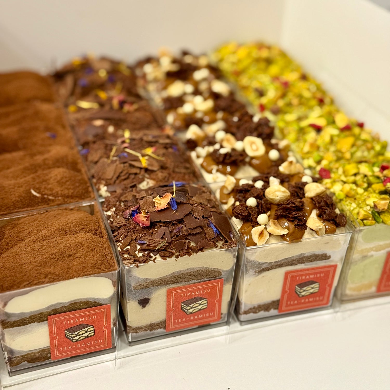 Assorted small Tiramisu cups in different flavours and toppings