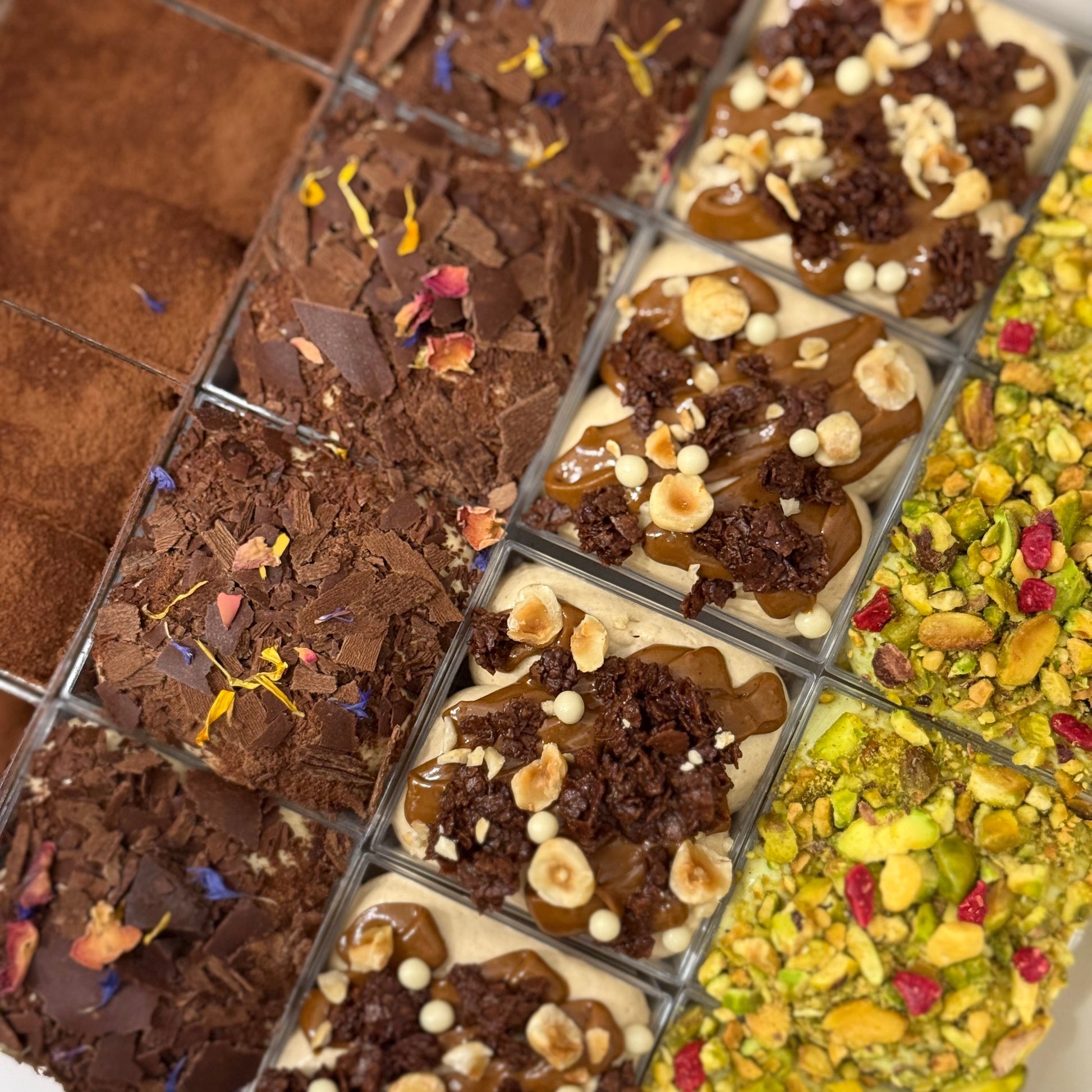 Assorted tiramisus in single serve cups with various toppings