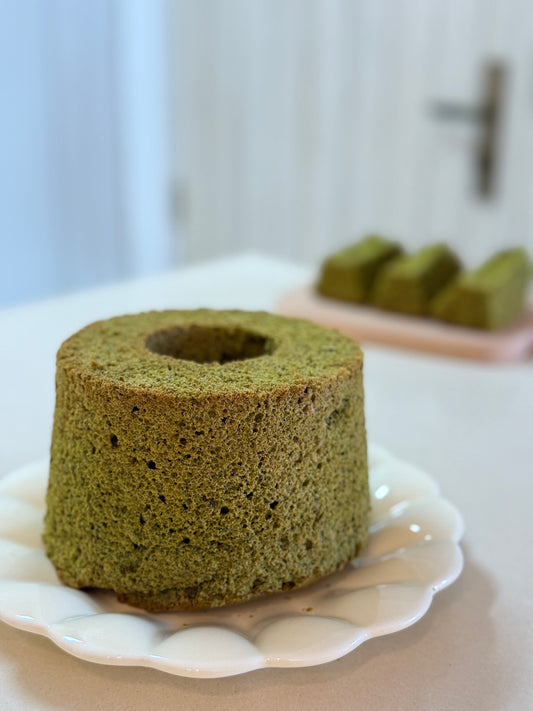 Whole 5” Matcha Chiffon Cake with slices in the background. Serves 6-8, homemade in Singapore